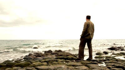 stock-footage-alone-man-standing-on-the-seashore